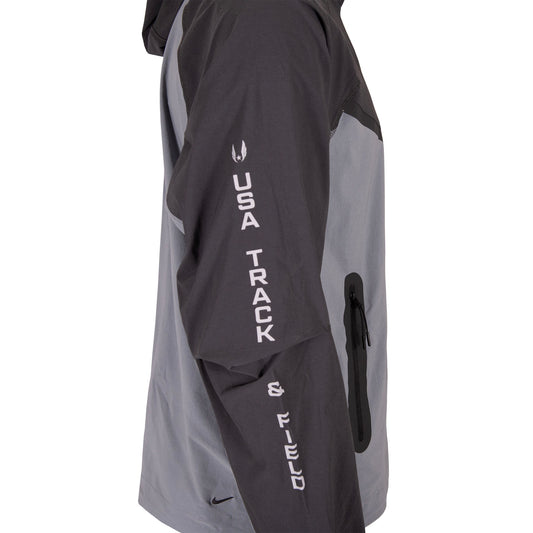 Gray and black athletic jacket with 'USA Track & Field' text on a white background