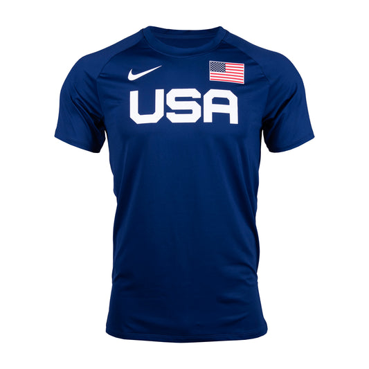 A blue Nike men's warm-up T-shirt with bold 'USA' lettering on the front and an American flag next to the brand's swoosh logo.
