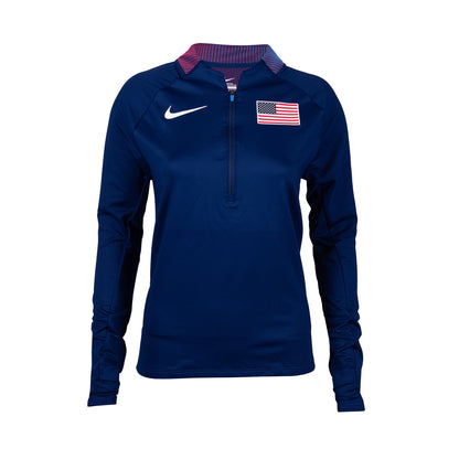 A navy Nike Team USA 1/2 zip top for women with a USA flag patch on the chest and the Nike swoosh logo.