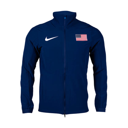 A navy blue Nike Team USA men's woven jacket with a front zipper, a small American flag on the left chest area, and the Nike logo on the right chest.