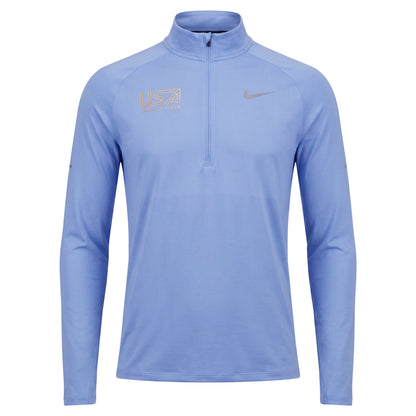 A light blue Nike long-sleeve quarter-zip athletic pullover with silver reflective USA Track & Field on wearer's right chest, shown on a plain white background.