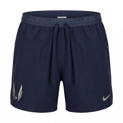Navy blue 5 inch Nike running shorts with a drawstring waist and elastic waistband, featuring a silver reflective USA Track & Field Federation logo on the wearer's right leg and a silver reflective Nike swoosh on the wearer's left leg.