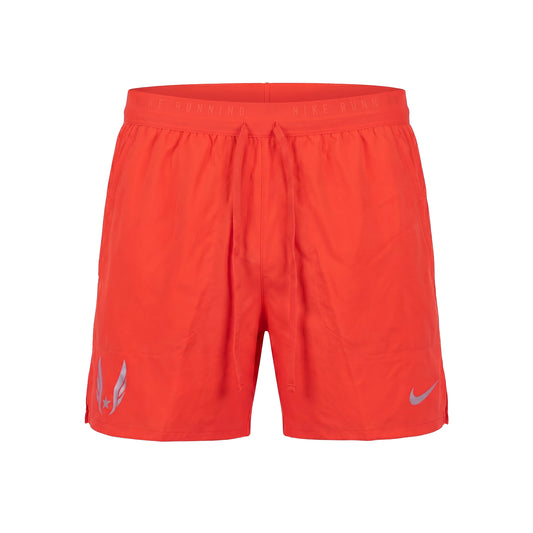 Red athletic shorts with a Nike logo on a white background
