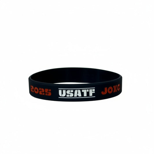 Navy wristband with red and white text on a light gray background